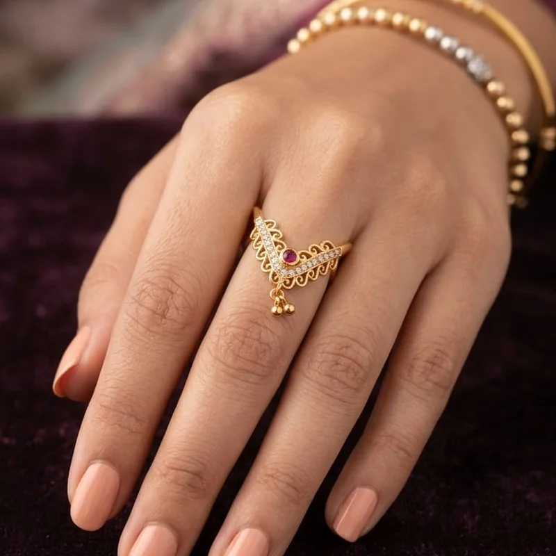 Front view of handcrafted brass Ruby V Halo Drop Ring with antique gold polish