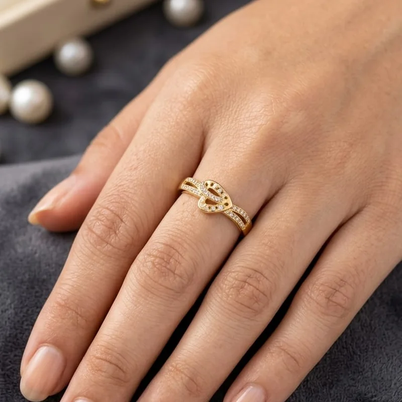 Front view of handcrafted brass Open Bow Pavé Ring with antique gold polish